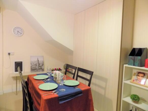 Cozy dining area with a neatly set table for fo...