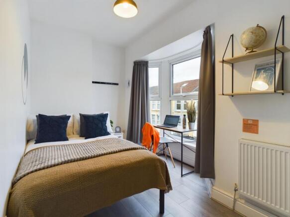 A bright and inviting double bedroom with ample...