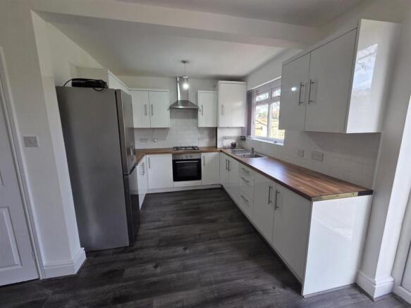 Modern kitchen with sleek white cabinetry...