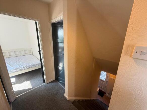 Bright first-floor landing with carpeted stairs...