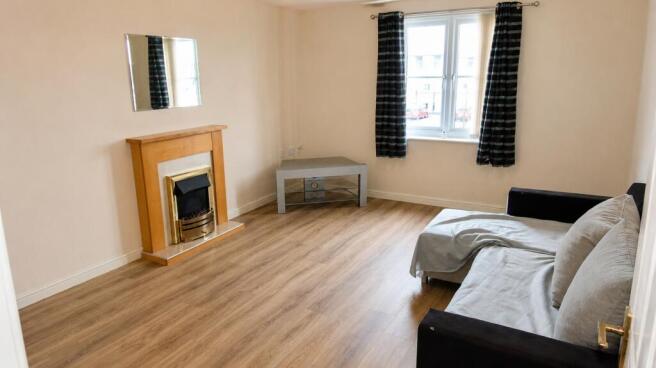 Bright living area with modern wood-style floor...