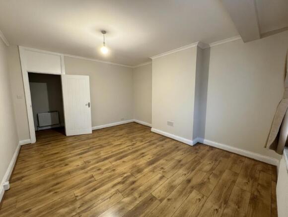 Bright, neutral living room with wood-effect fl...