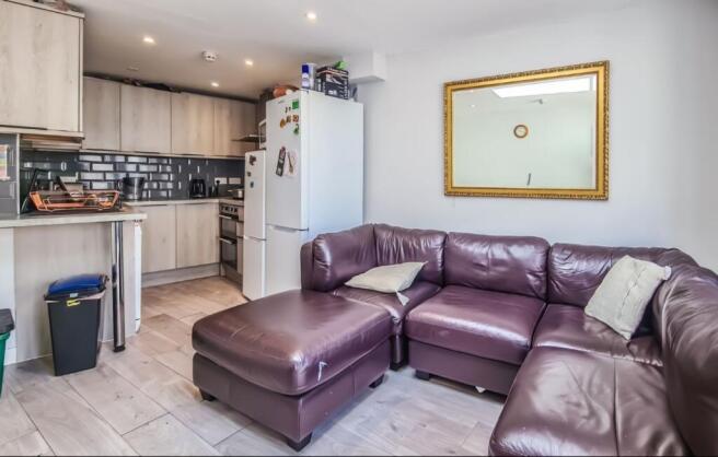 Modern open-plan living area with comfy sofa...