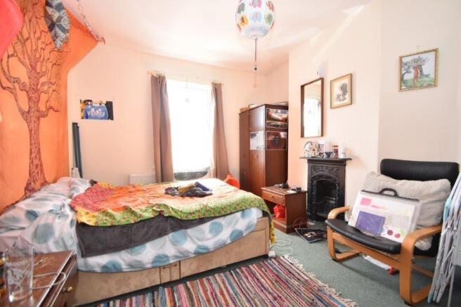 Bright, cosy bedroom with a double bed, colourf...