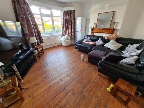 A bright, spacious living room featuring large ...