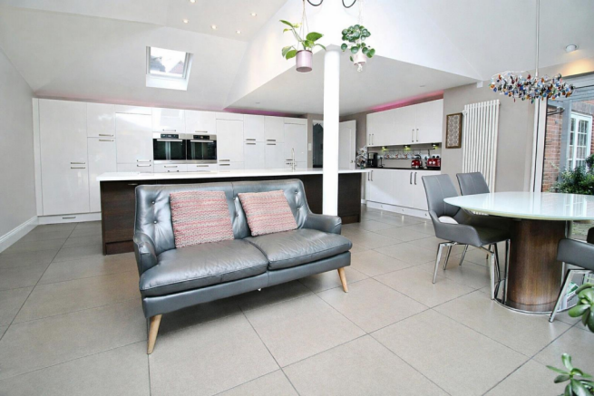 Modern open-plan living space with pops of colour.