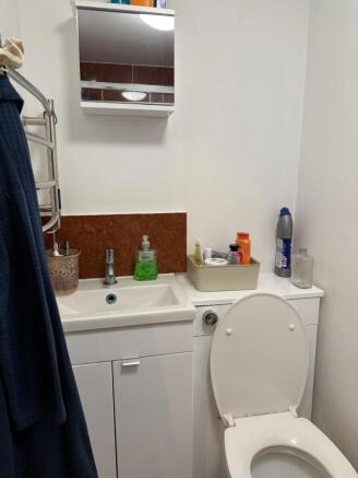 Bright bathroom with vanity and mirrored cabine...