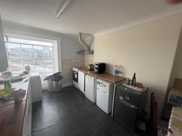 Bright kitchen with ample natural light and sto...