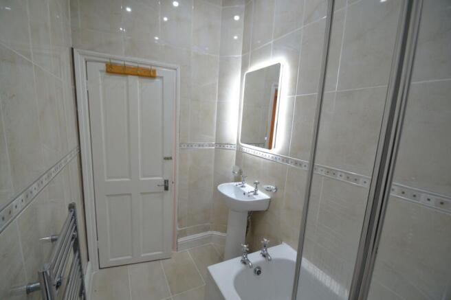 Bright and clean bathroom featuring a modern mi...