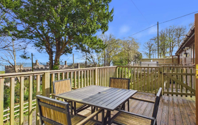 Outdoor Dining Area On The Lodge Decking With Coas