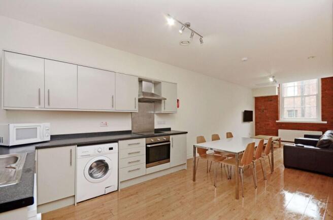 Bright open-plan kitchen and dining area with s...