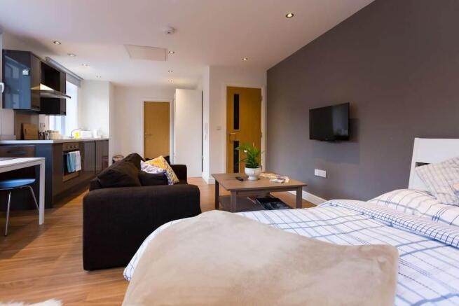 Modern studio with sleek kitchen and living are...