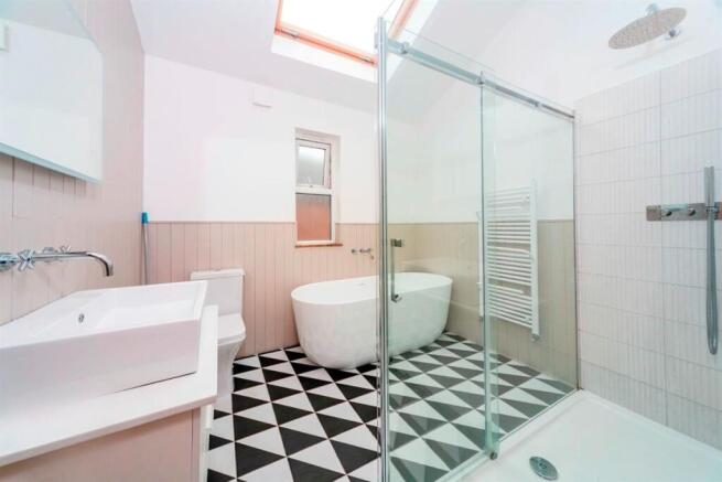 Modern bathroom with freestanding bath and show...