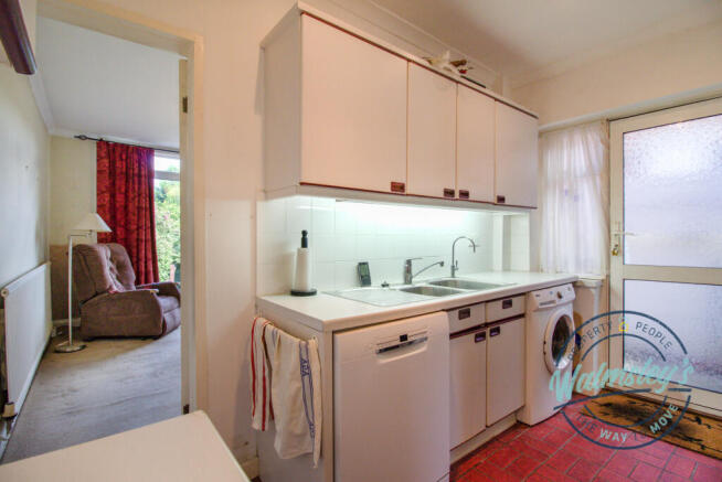 Kitchen towards second sitting room at rear