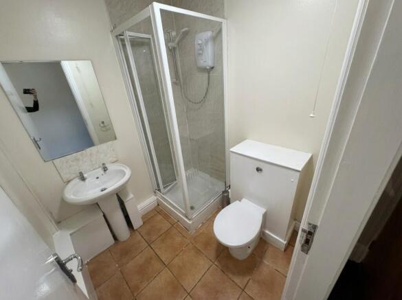 Bright bathroom with modern glass shower cubicl...