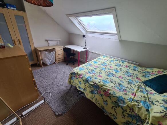 A spacious and bright master bedroom featuring ...