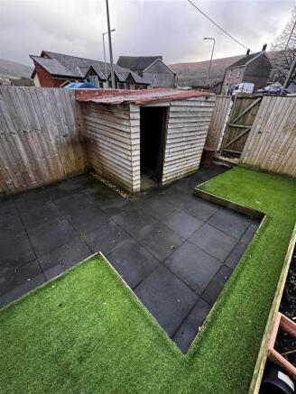 Private paved garden with artificial lawn...