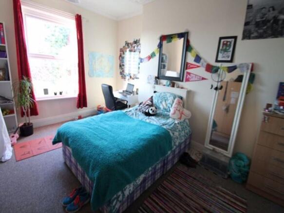 A cozy and well-maintained student bedroom with...