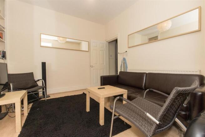 Cosy lounge with sleek leather sofa and mirrors...