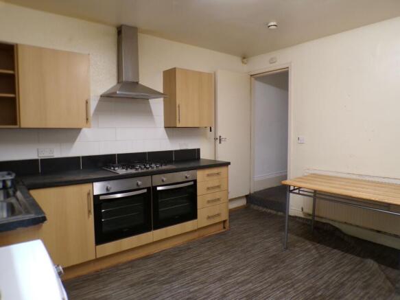 Bright kitchen with modern oven and hob, stainl...