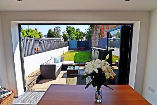 Sun-drenched garden with stylish patio seating...