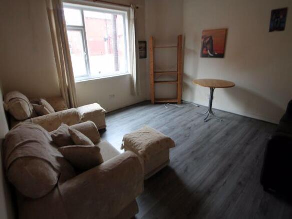 A cozy living room featuring a soft armchair an...