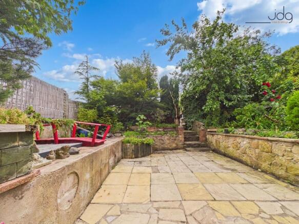 Spacious Flagged Garden with pond
