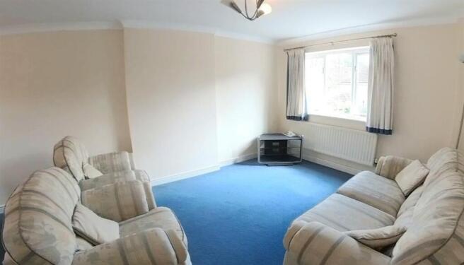 Bright, neutrally decorated living room with la...