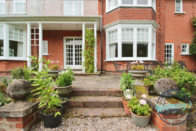 Patio & French doors to hallway from gardens