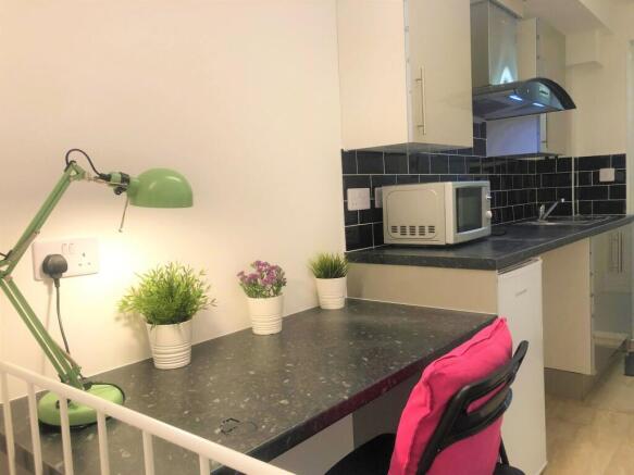 Bright and tidy kitchen space featuring a sleek...