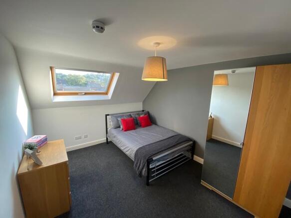 Bright, modern double bedroom with a skylight w...