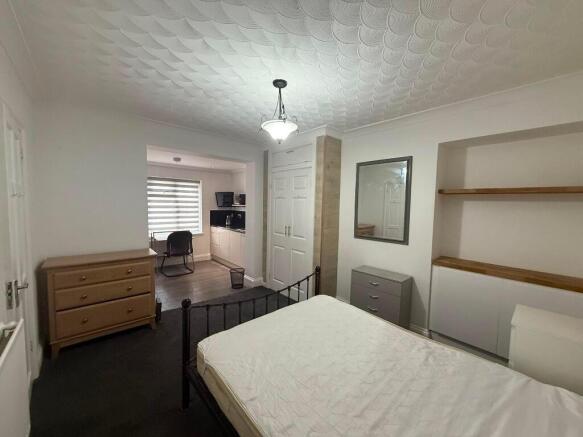 Bright, well-presented bedroom with a metal dou...