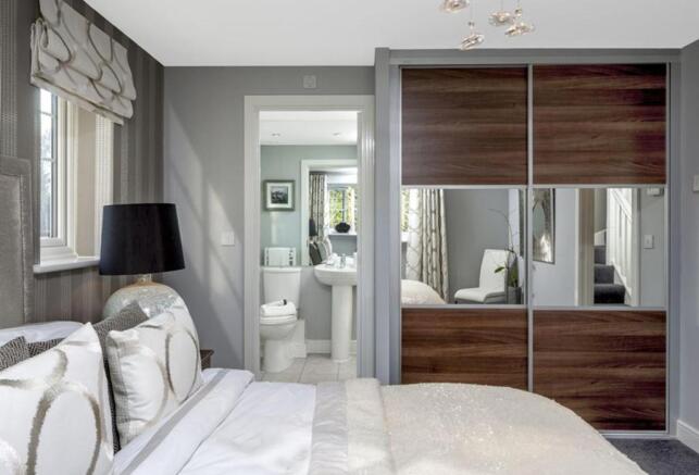 Master bedroom featuring an en suite shower room