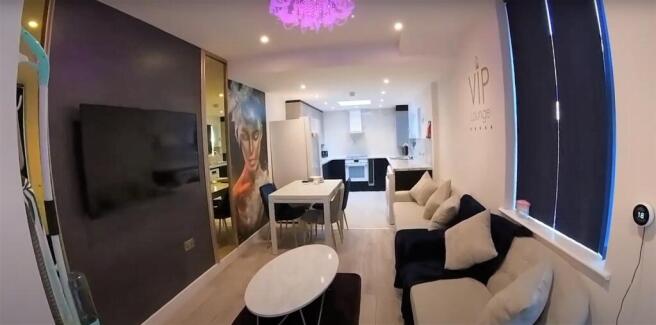 Modern open-plan lounge with smart TV and seati...