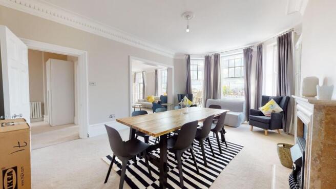 Bright and spacious living room featuring large...