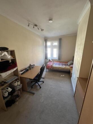 Bright bedroom with large desk and ample storag...