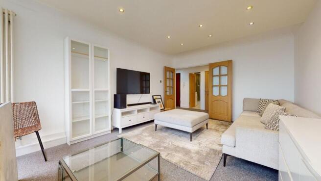 Bright and spacious modern living area with TV...