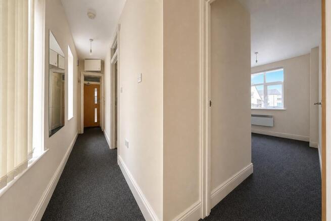 Bright, clean hallway with modern neutral decor...