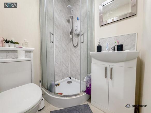 Modern ensuite with sleek corner shower unit...