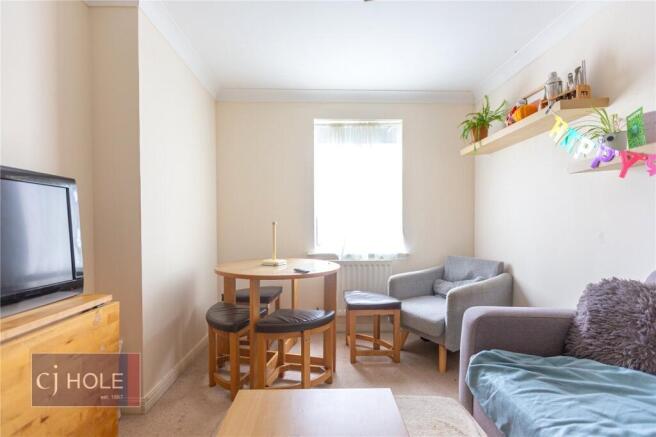 A cozy living room with soft natural light from...