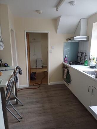 Bright fitted kitchen with a worktop, integrate...