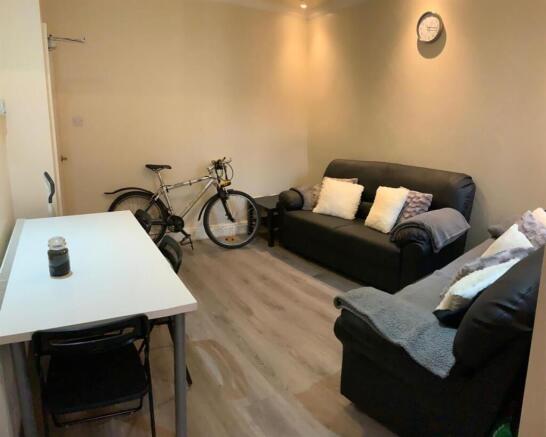 Cozy living room with comfy sofas and dining ta...