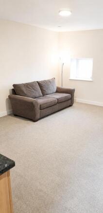Bright and airy lounge with comfy plush sofa...