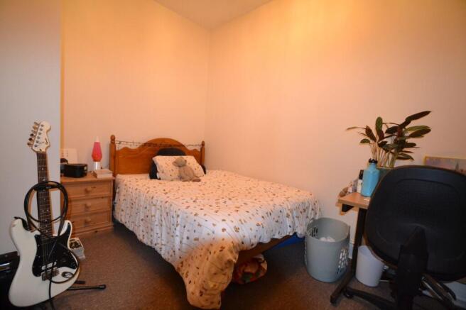 Cozy double bedroom featuring a comfortable bed...