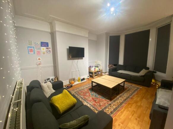 A spacious, well-lit living room featuring mode...