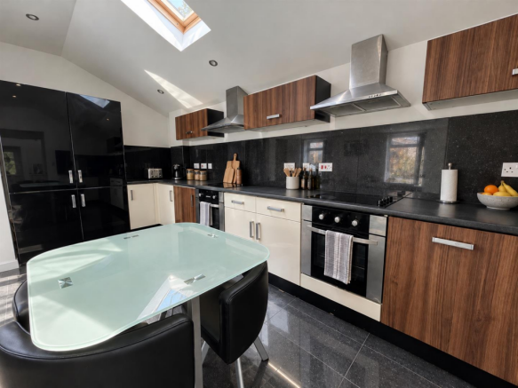 Sunlit Modern Kitchen with Glass Dining Table.png