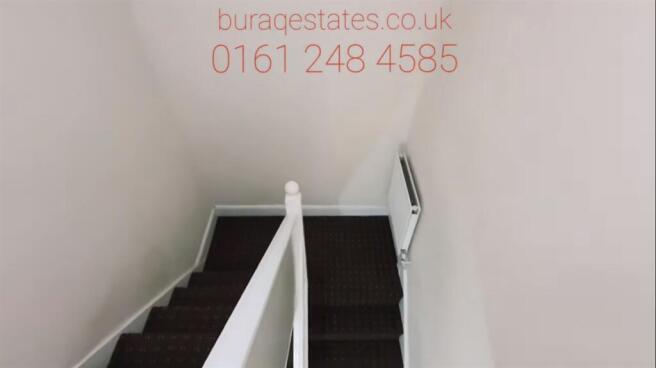Clean, carpeted staircase and landing with whit...
