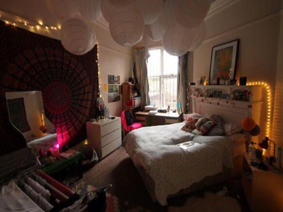 A cozy and inviting master bedroom featuring a ...