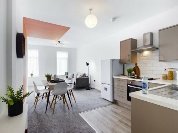 A modern and spacious kitchenette with ample na...