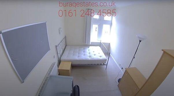 Bright bedroom with large window and study desk...